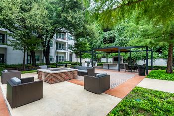 a patio with furniture and a fire pit